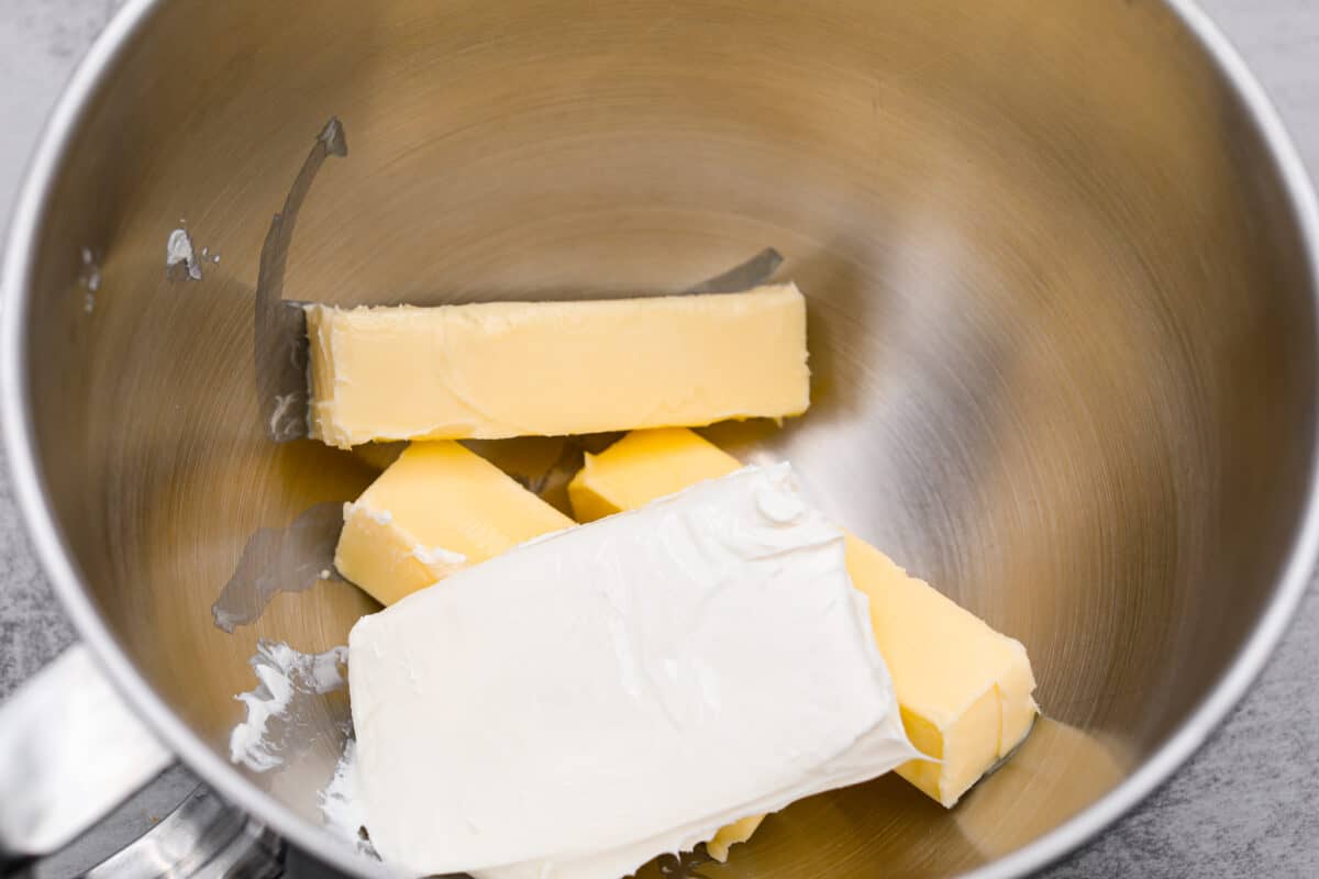 The cream cheese and butter being added to a mixing bowl. - Cream Cheese Pound Cake