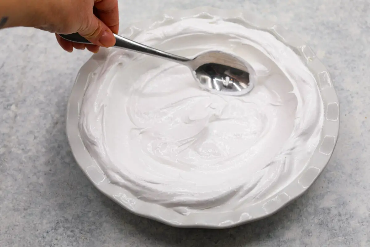 Second process photo of the meringue spread inside the pie dish. - Lemon Angel Pie