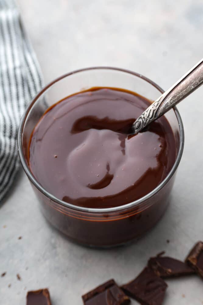 An overhead view of chocolate ganache in a glass container. - Easy Chocolate Ganache