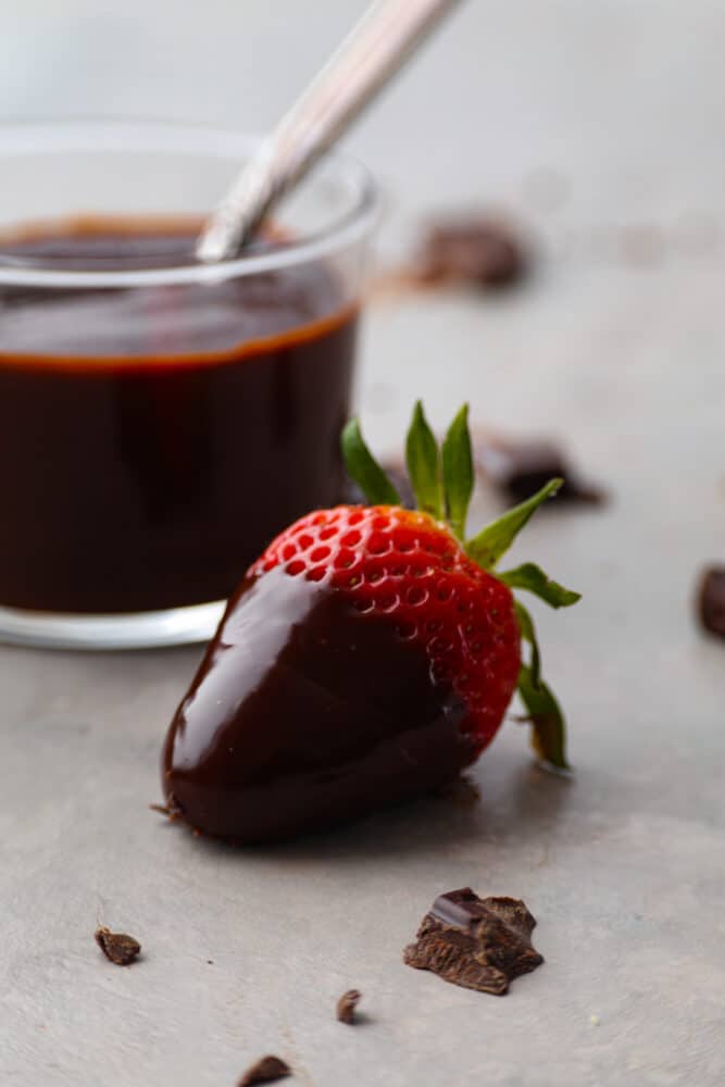 A strawberry dipped in chocolate ganache. - Easy Chocolate Ganache
