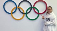 Kelly Curtis next to the olympic rings at the 2022 Winter Olympics in Beijing China - Kelly Curtis Stays Fit To Serve As An Olympian And Future Mom