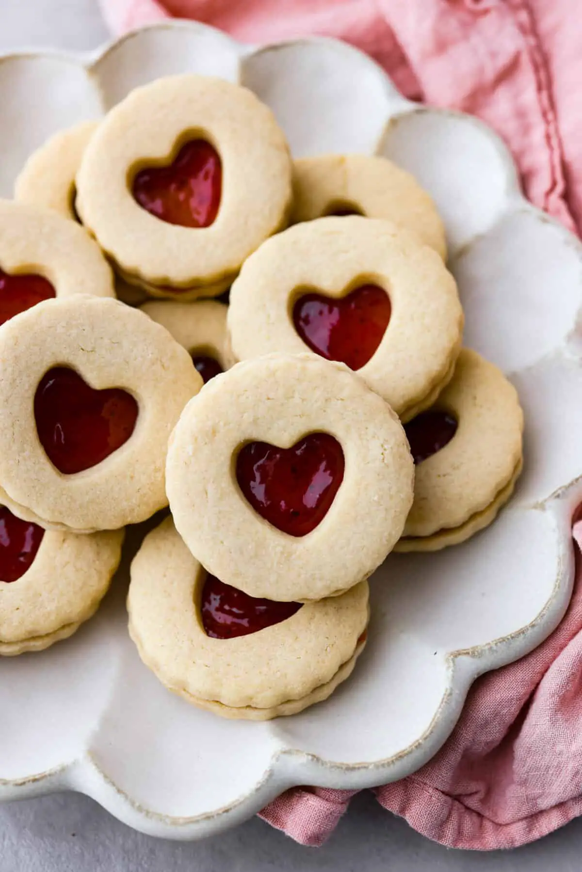 Cookies served in a white, scalloped dish. - Jammie Dodgers