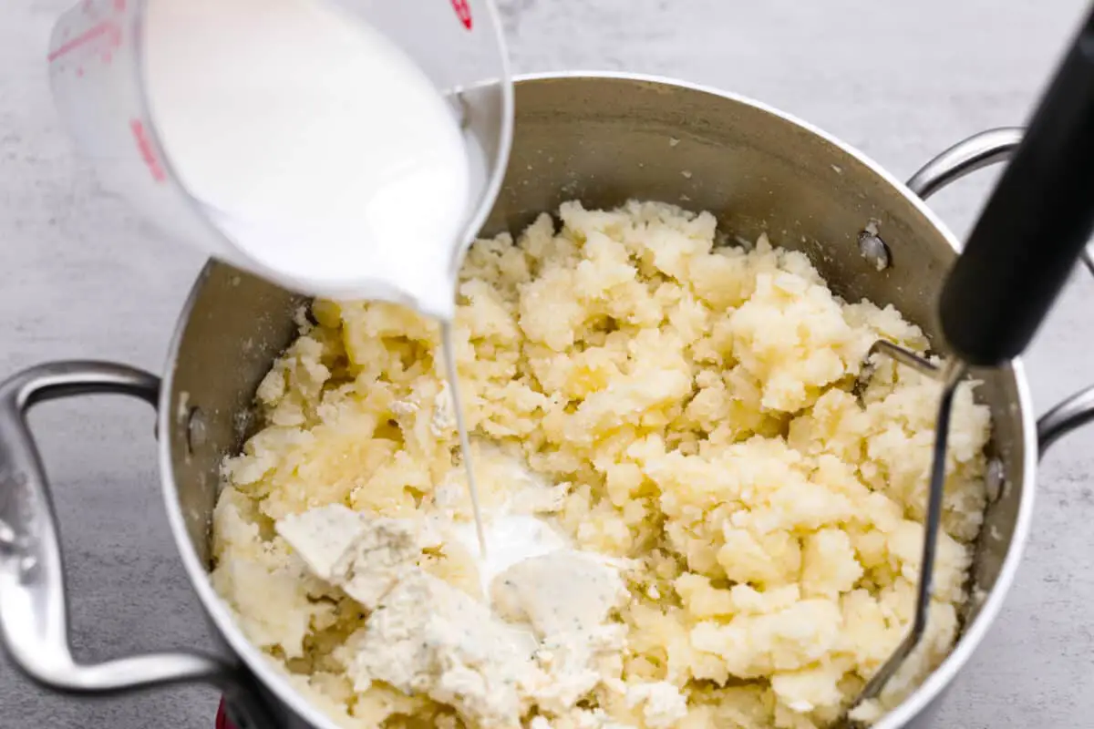 Mashing the potatoes and adding cream. - Homemade Shepherd’s Pie