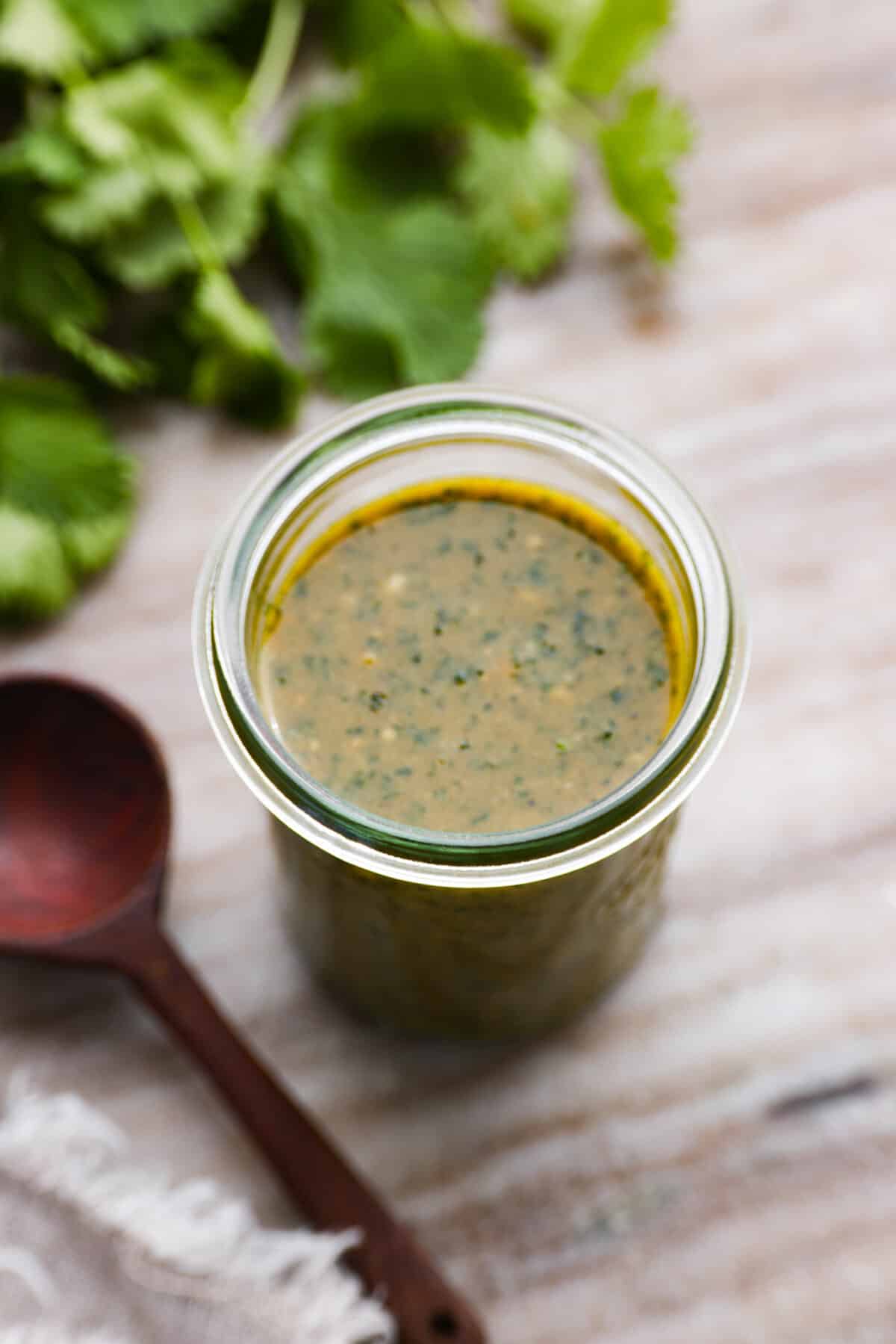 Green dipping sauce in a glass jar. - Tamarind Cashew Dipping Sauce