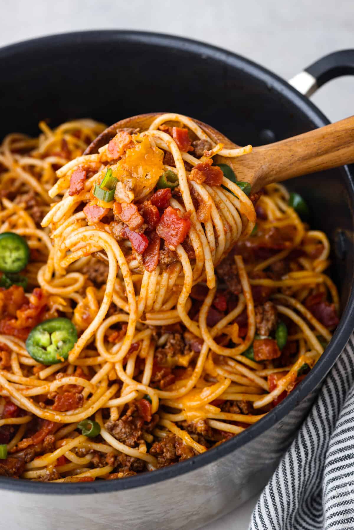 A scoop of spaghetti on a wooden spoon. - Cowboy Spaghetti
