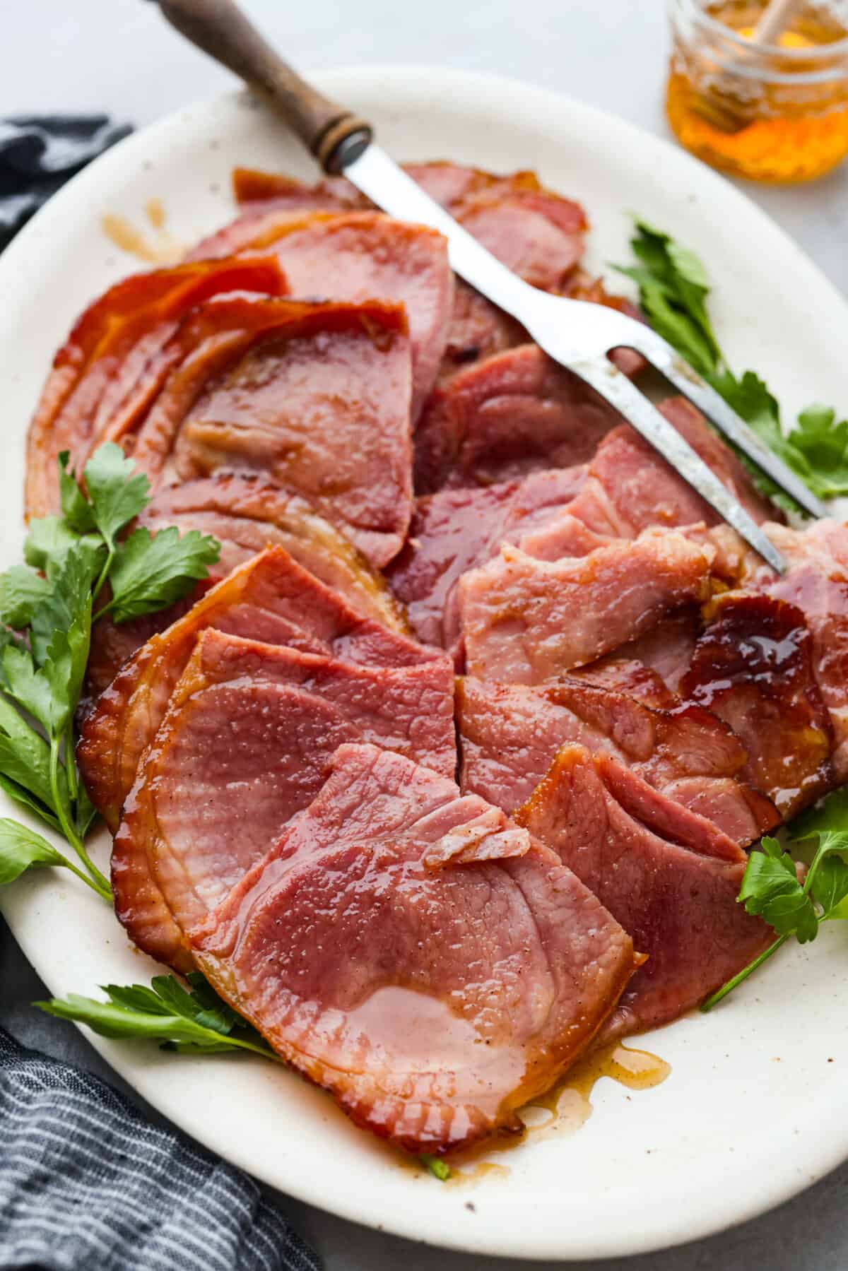 A honey glazed ham, cut into slices. - Classic Honey Glazed Ham
