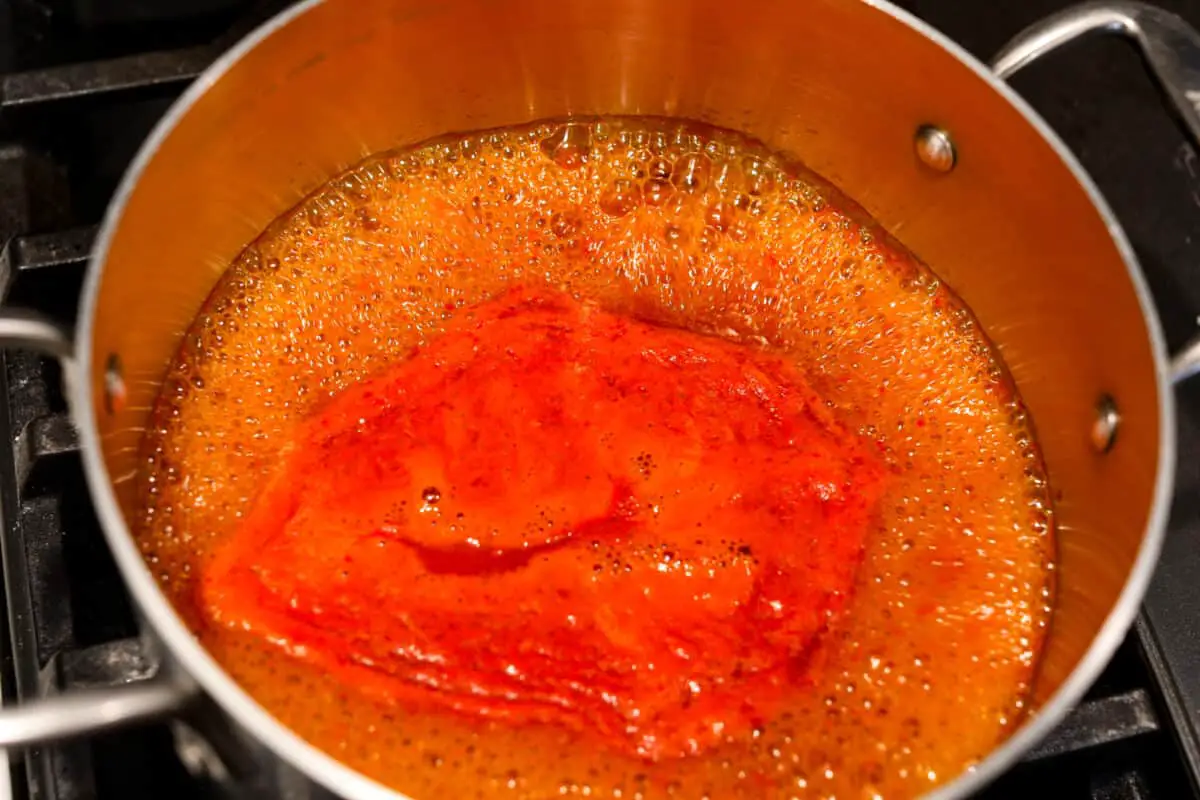 Simmering all of the hot sauce ingredients together. - Homemade Hot Sauce