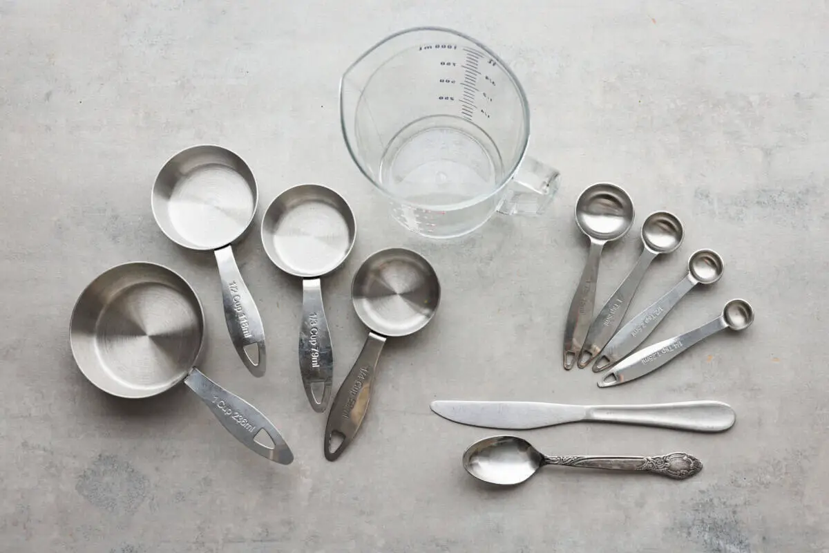 Measuring cups and spoons laid out on the counter. - How To Properly Measure Baking Ingredients