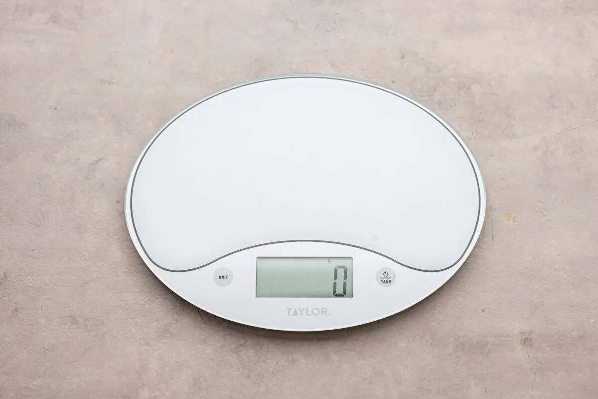 A food scale set to zero. - How To Properly Measure Baking Ingredients