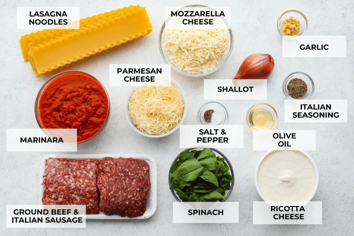 A top view of all of the ingredients for sheet pan lasagna in individual bowls, each labeled. - Easy Sheet Pan Lasagna