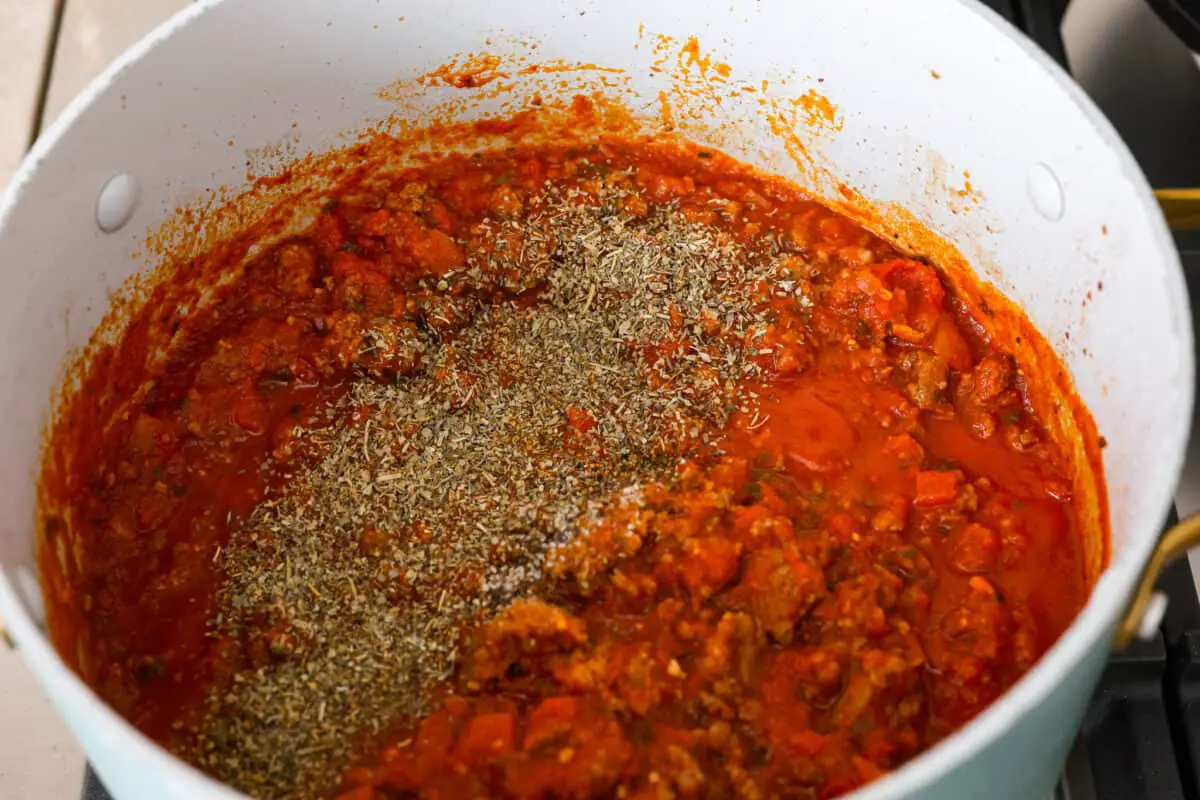 Marinara mixed with meat in a pot. - Easy Sheet Pan Lasagna