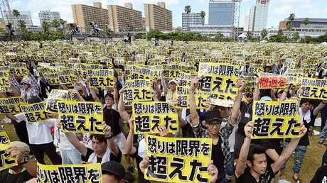 FILE PHOTO: Protesters raise placards reading - ‘No Ospreys In Our Skies!’ Okinawa Governor Leads Mass Protest Against US Military Bases (VIDEO) — RT News