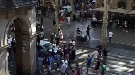 People move from the scene after a van crashed into pedestrians near the Las Ramblas avenue in central Barcelona, Spain August 17, 2017 © McKenzie Tavoda / Reuters - Extremely Graphic Footage Emerges From La Ramblas Attack — RT News