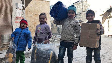 FILE PHOTO. Children receive the first humanitarian aid in eastern Aleppo. © Mikhail Alaeddin - Humanitarian Needs Of People Of Aleppo Are ‘huge’, Basic Services Still Need To Be Restored – ICRC — RT News