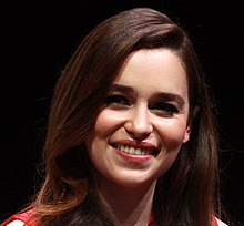This image has an empty alt attribute; its file name is 220px-Emilia_Clarke_by_Gage_Skidmore_2_%28cropped%29.jpg - Emilia Clarke Revealed She Tried To Take Her Daenerys Wig From The Set Of "Game Of Thrones"