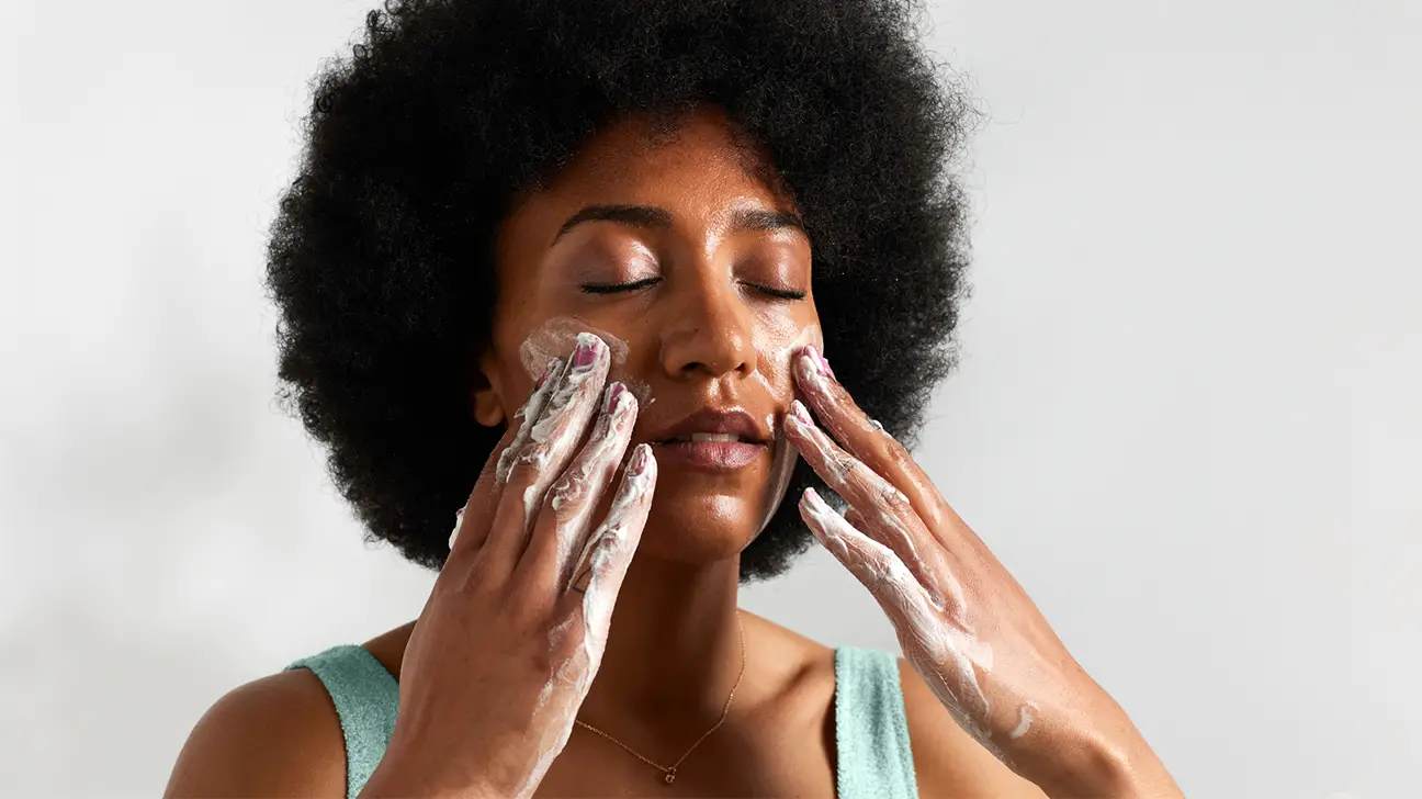 person washing their face - Skin Care 101: How To Deal With Big Nose Pores