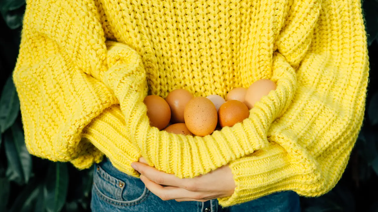 Woman holding eggs - How Eggshells And Coffee Grounds Can Make Your Garden Grow