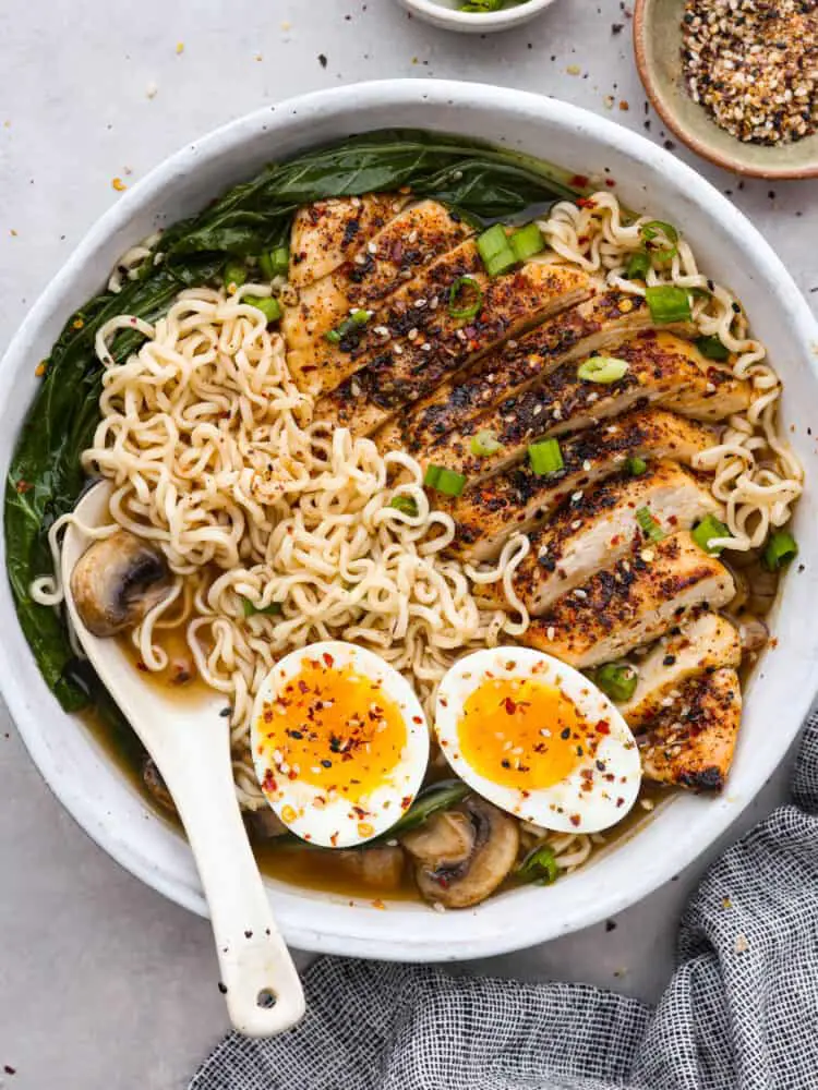 Top-down view of homemade ramen topped with chicken, bokchoy, and a soft boiled egg. - Easy Homemade Ramen