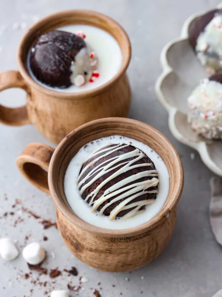 A hot chocolate bomb in a mug filled with milk. - Homemade Hot Chocolate Bombs