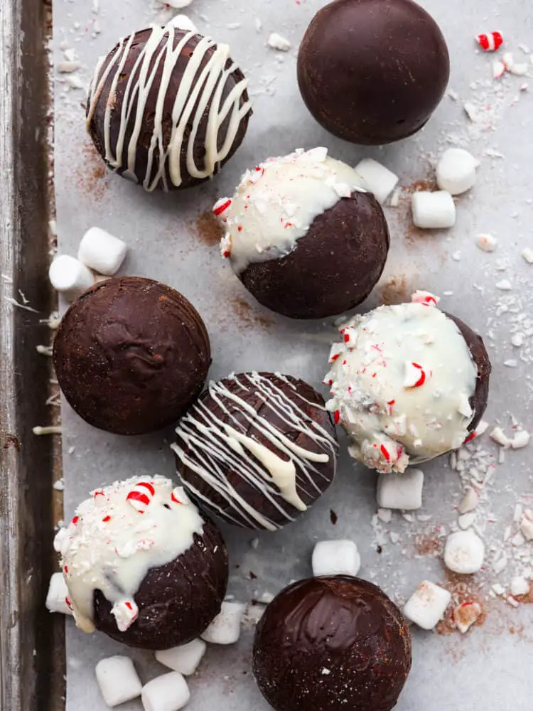 Top-down view of hot cocoa bombs laid out on a baking sheet lined with parchment paper. - Homemade Hot Chocolate Bombs