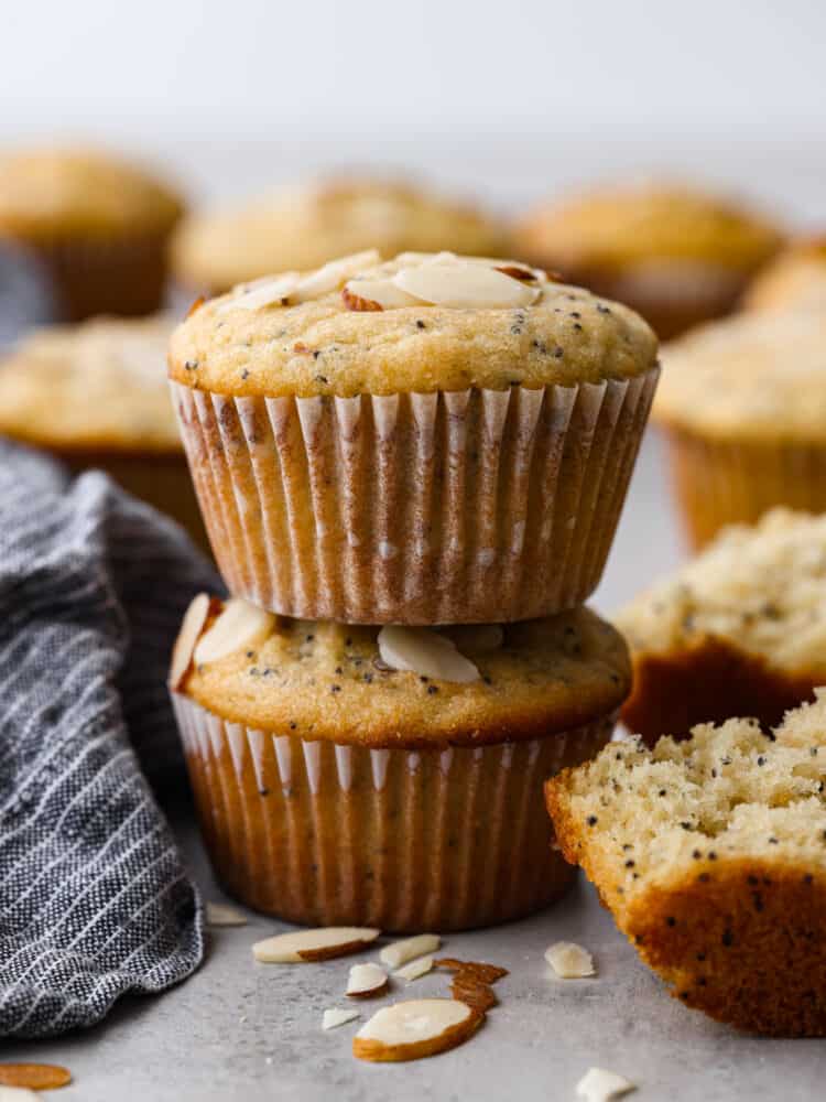 2 muffins stacked on top of each other. - Almond Poppy Seed Muffins