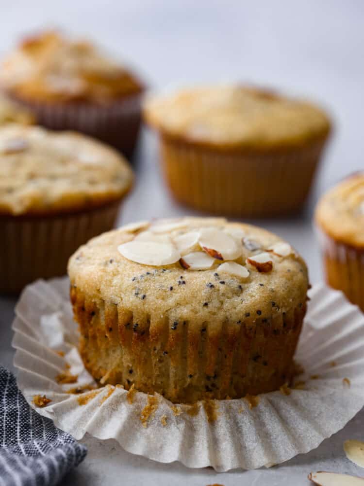 An almond poppy seed muffin with the cupcake liner unwrapped. - Almond Poppy Seed Muffins