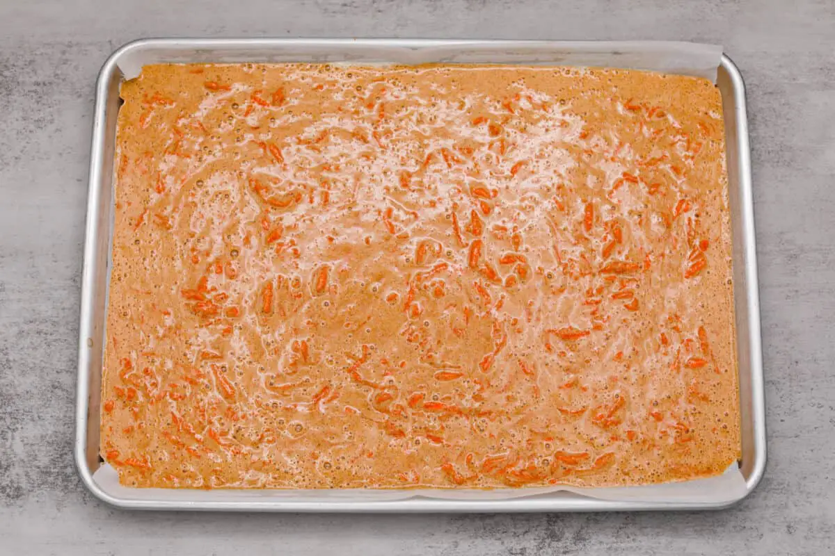 Batter poured into a baking dish. - Carrot Cake Roll