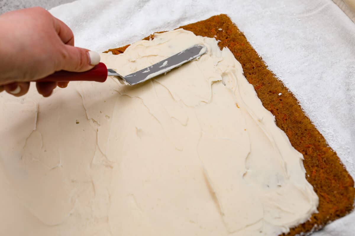 Spreading the cream cheese filling over the cake - Carrot Cake Roll