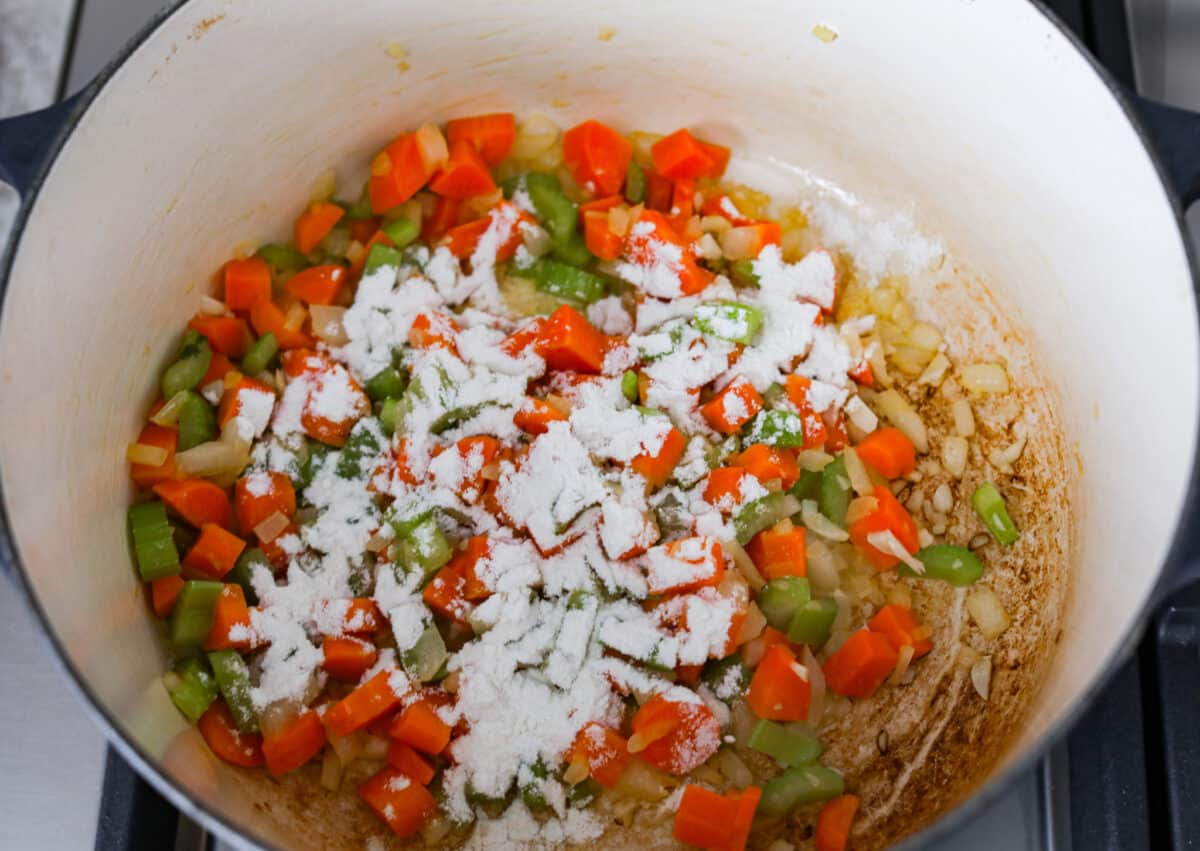 Second process photo of the flour sprinkled over the veggies. - Ham And Bean Soup