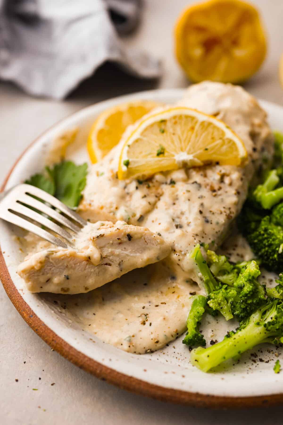 A serving of the recipe on a stoneware plate. - Creamy Lemon Parmesan Chicken