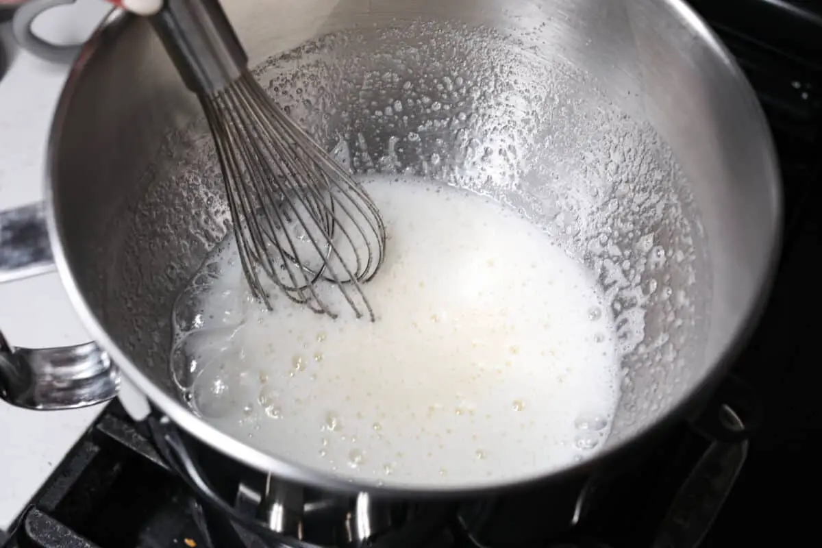Whisking the egg whites and sugar together. - Swiss Meringue Buttercream